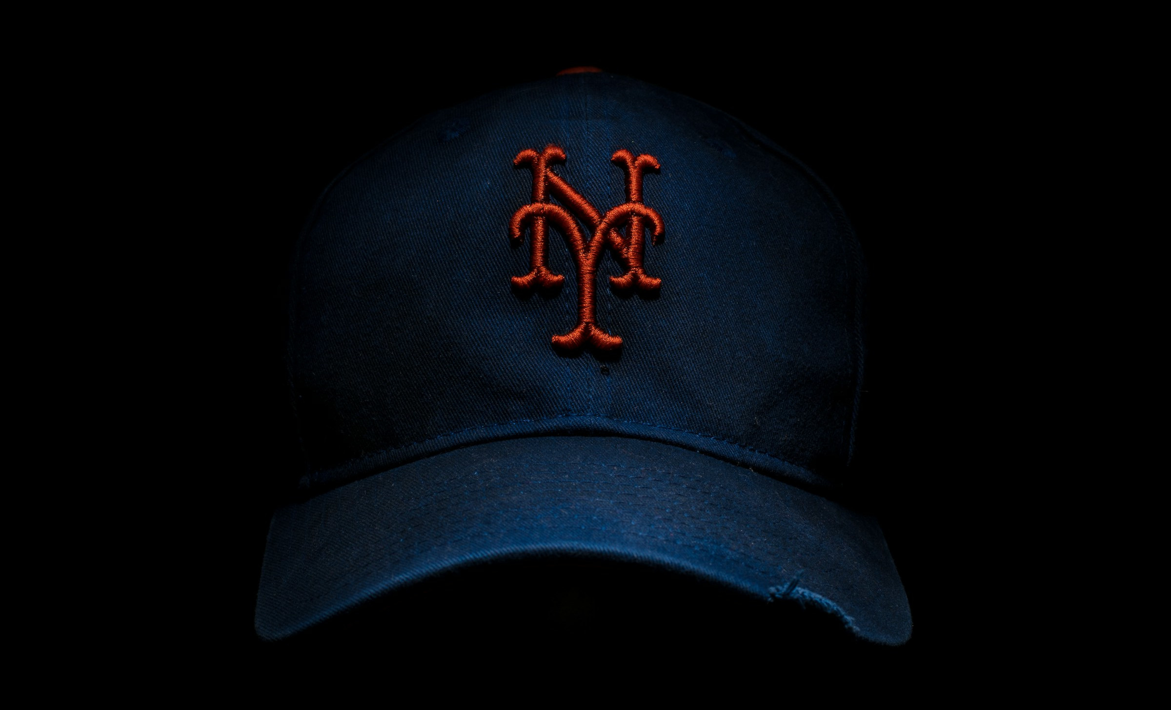 Mets hat against a black background